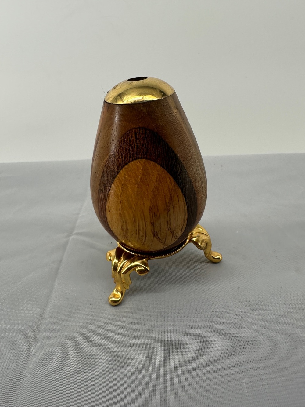 Wooden kaleidoscope egg with ornate stand